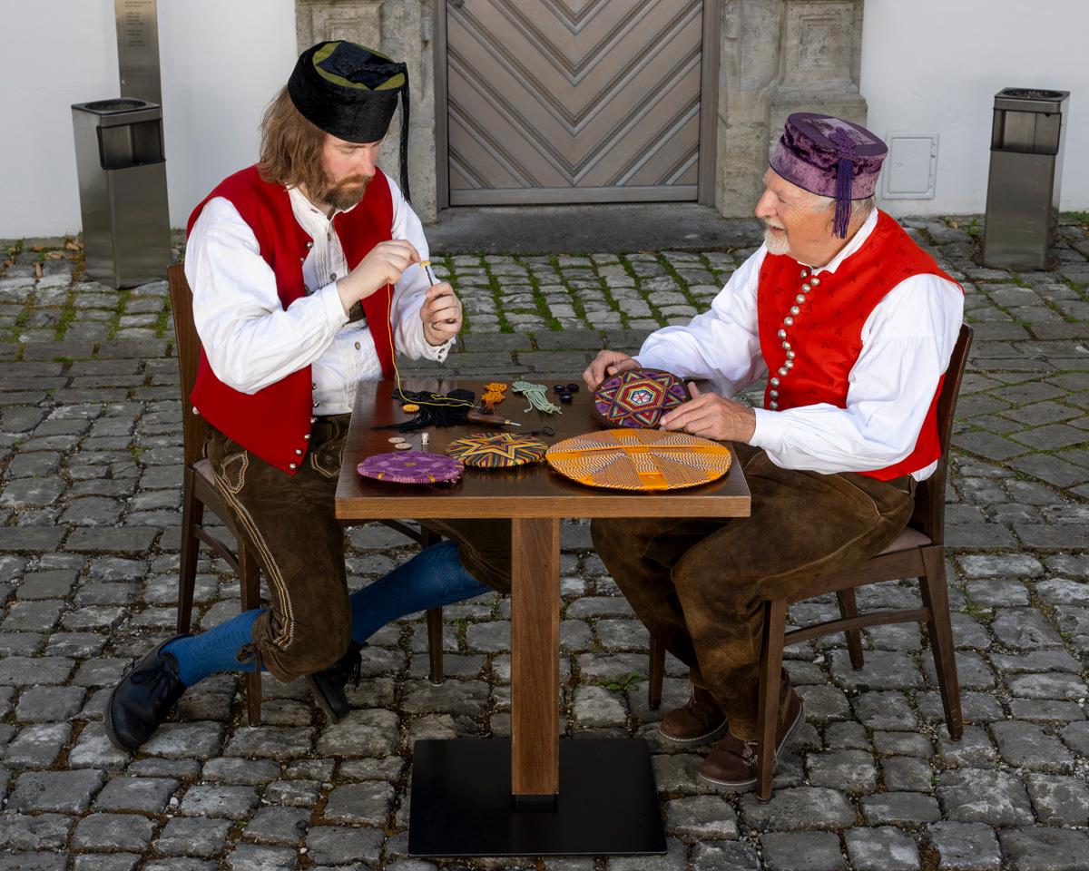 Zwei Männer bei der Knopfmacherei